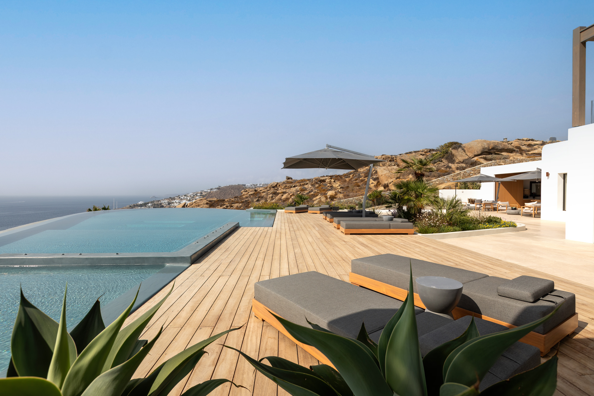 Poolside loungers and the Aegean Sea beyond